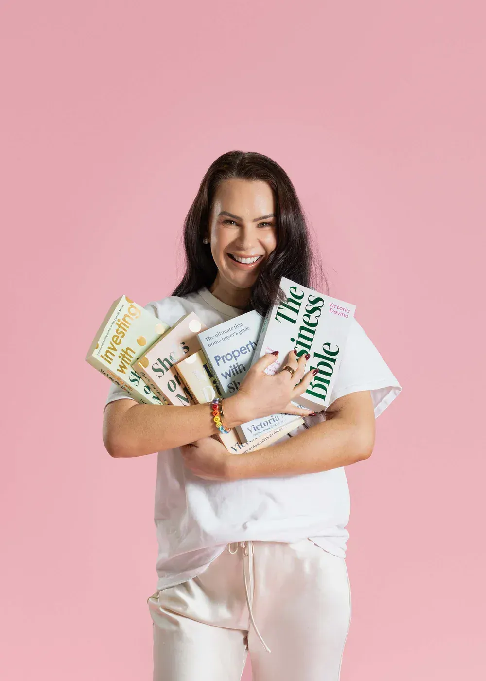 Victoria Devine holding her books from She's On The Money